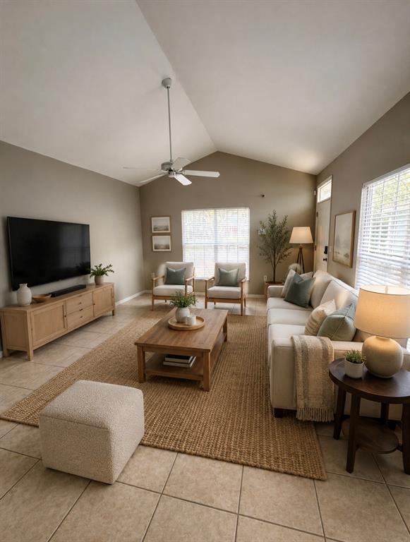 A living room features a vaulted ceiling, a beige sofa, two armchairs, and a television — 248 ST IVES DRIVE UNIT 248, PALM HARBOR, FL