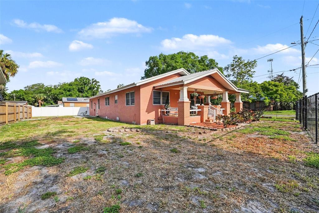A single-story house with a peach-colored stucco exterior and a covered front porch — 9907 MAGGIE STREET, GIBSONTON, FL