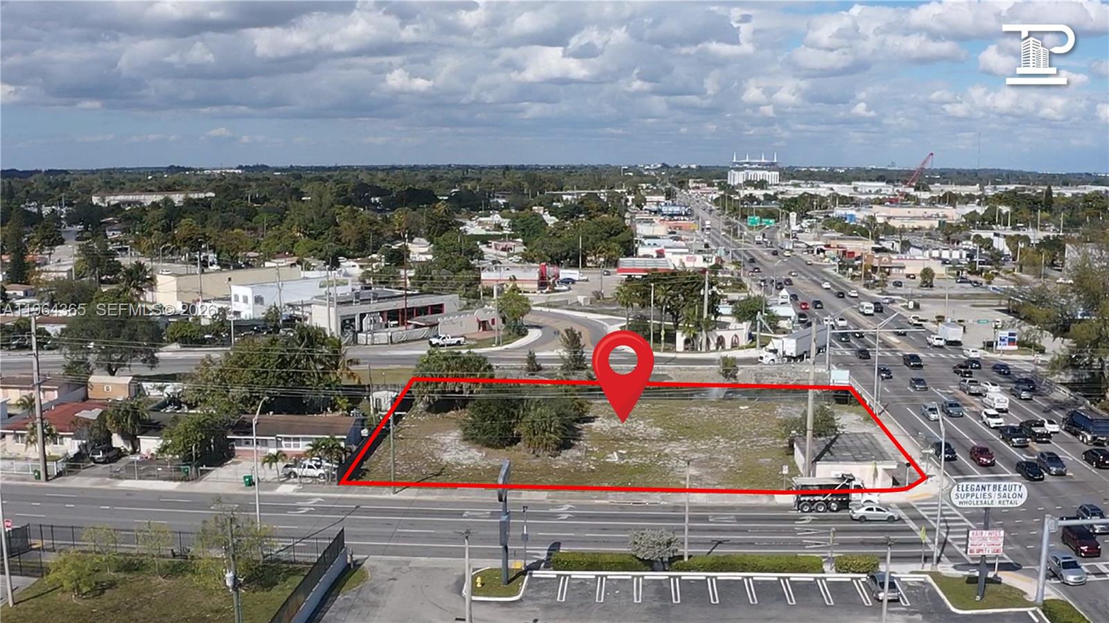 An aerial view shows a vacant, rectangular lot outlined in red along a busy road — 13510 NW 27th Ave, Opa-Locka FL 33054, OPA-LOCKA, FL