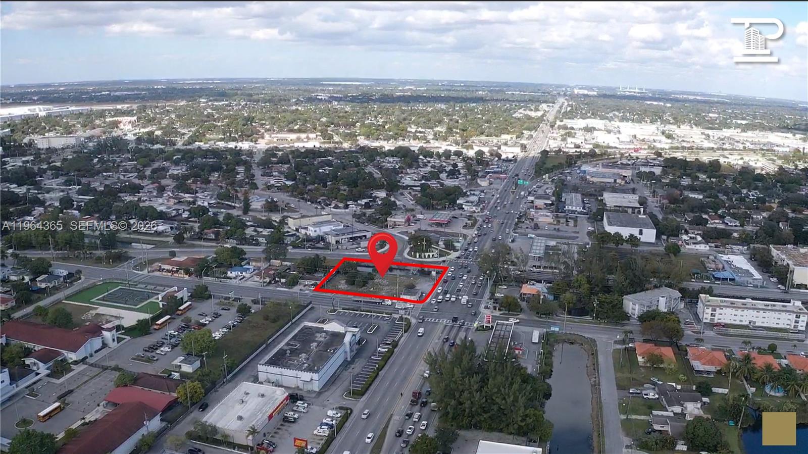 An aerial view shows a vacant, rectangular lot outlined in red near a busy intersection — 13510 NW 27th Ave, Opa-Locka FL 33054, OPA-LOCKA, FL