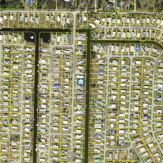 This is an aerial map showing a residential neighborhood with houses and canals — 1275 FLAMINGO DRIVE, ENGLEWOOD, FL
