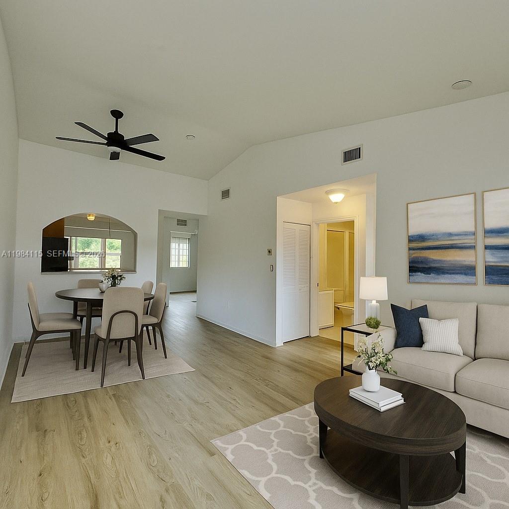 This is a digital rendering of an open-concept living and dining area with light flooring — 975 NE 33rd Ter # 203, Homestead FL 33033, HOMESTEAD, FL