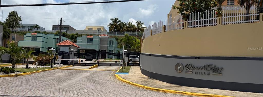 The gated entrance to the River Edge Hills residential community features a paved driveway — A18 CALLE RIO FAJARDO, LUQUILLO, PR