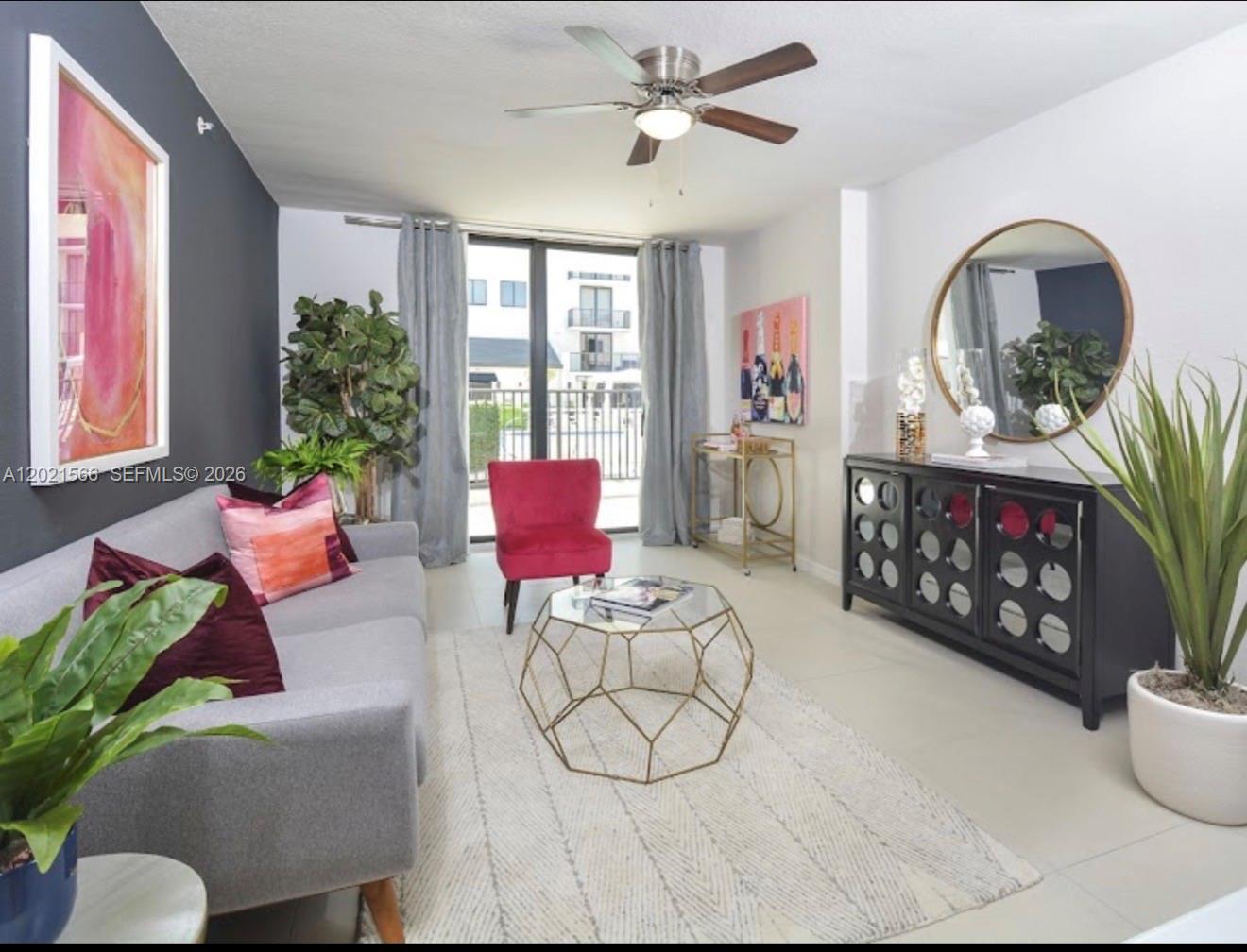 A modern living room features a gray sofa, a geometric coffee table, and a round mirror — 2001 NW 67th St # 110, West Miami FL 33147, WEST MIAMI, FL