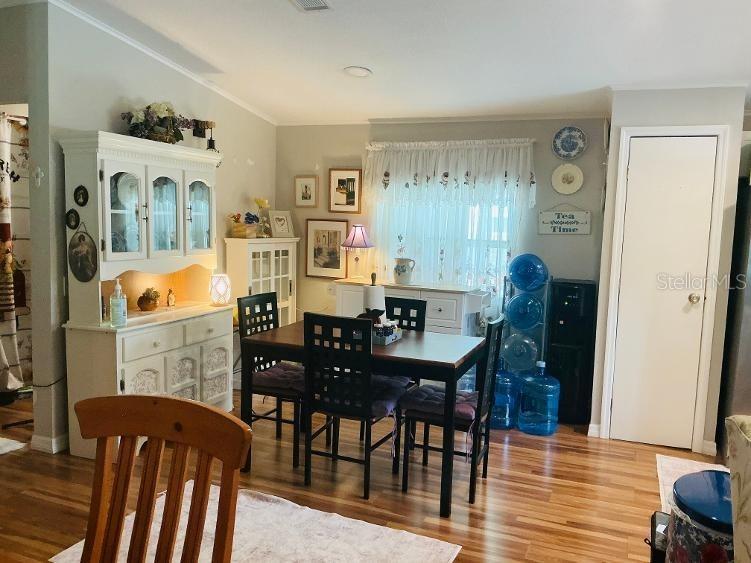 A single-story manufactured home features a white exterior, a carport, and a gravel front yard — 10325 MARINETTE, HUDSON, FL