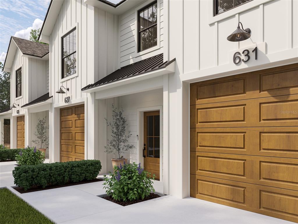 This digital rendering shows the exterior of two modern townhomes with white siding and garages — 124 N MILLER ROAD, VALRICO, FL