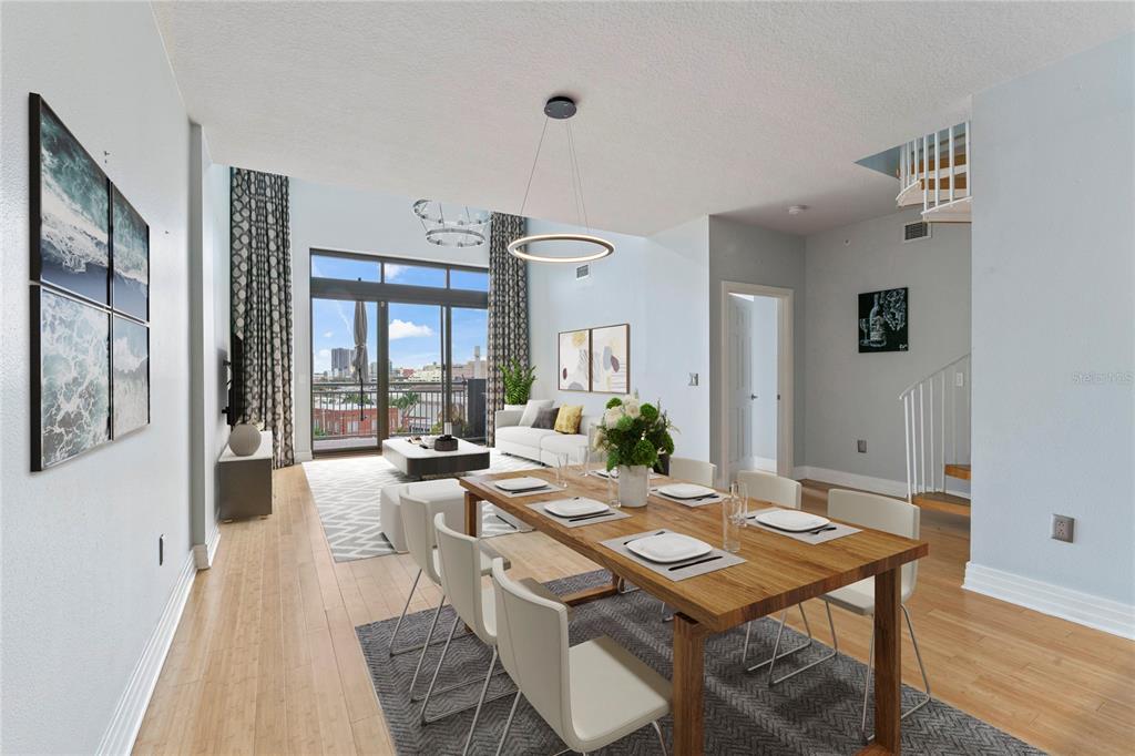 A dining area and living room with high ceilings, hardwood floors, and a balcony view — 1108 N FRANKLIN STREET UNIT 707, TAMPA, FL