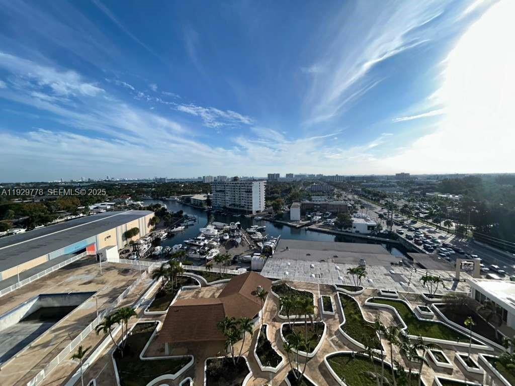 An elevated view shows a marina, surrounding buildings, and a landscaped courtyard with palm trees — 13499 Biscayne Blvd # 1206, North Miami FL 33181, NORTH MIAMI, FL