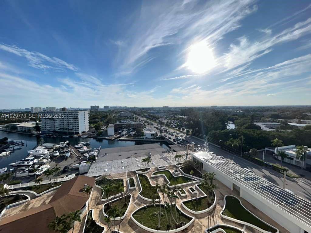 An elevated view shows a marina, a landscaped courtyard, and a road with traffic — 13499 Biscayne Blvd # 1206, North Miami FL 33181, NORTH MIAMI, FL