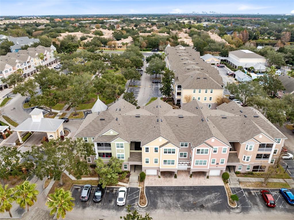 An aerial view shows a multi-story apartment complex with parking lots and surrounding trees — 3315 PARKCHESTER SQUARE BOULEVARD UNIT 102, ORLANDO, FL