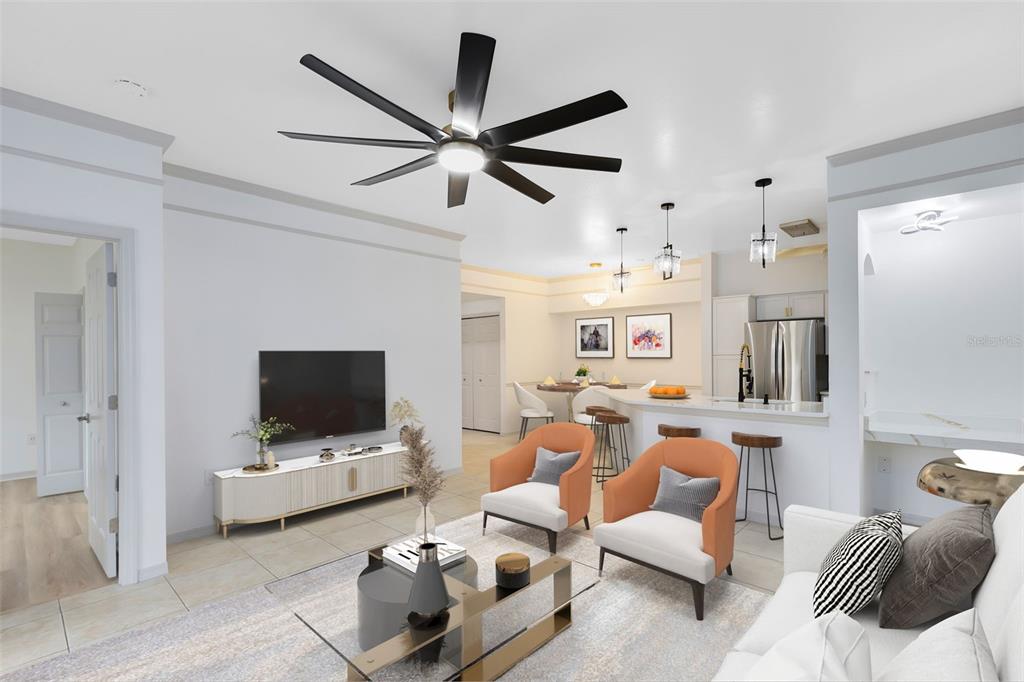 This open-concept living room features a ceiling fan, orange armchairs, and an adjacent kitchen — 3315 PARKCHESTER SQUARE BOULEVARD UNIT 102, ORLANDO, FL