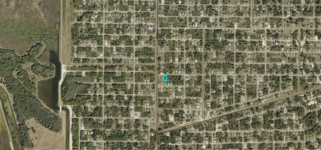 This is an aerial map view of a residential neighborhood with a highlighted vacant lot — 3013 38TH STREET W, LEHIGH ACRES, FL