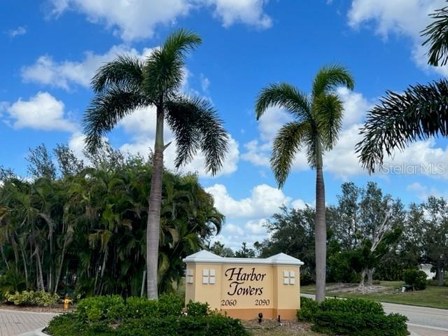 A sign for Harbor Towers stands between two palm trees under a blue sky — 2090 MATECUMBE KEY ROAD UNIT 1105, PUNTA GORDA, FL