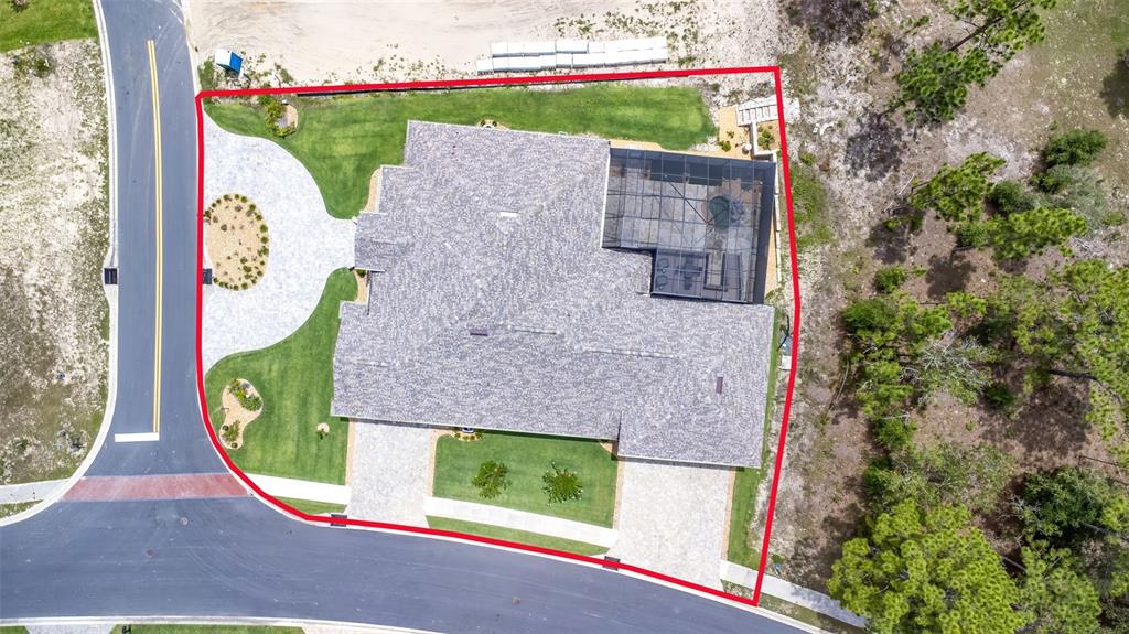 An aerial view shows a house with a screened-in pool enclosure on a corner lot — 17898 SW 72ND STREET ROAD, DUNNELLON, FL
