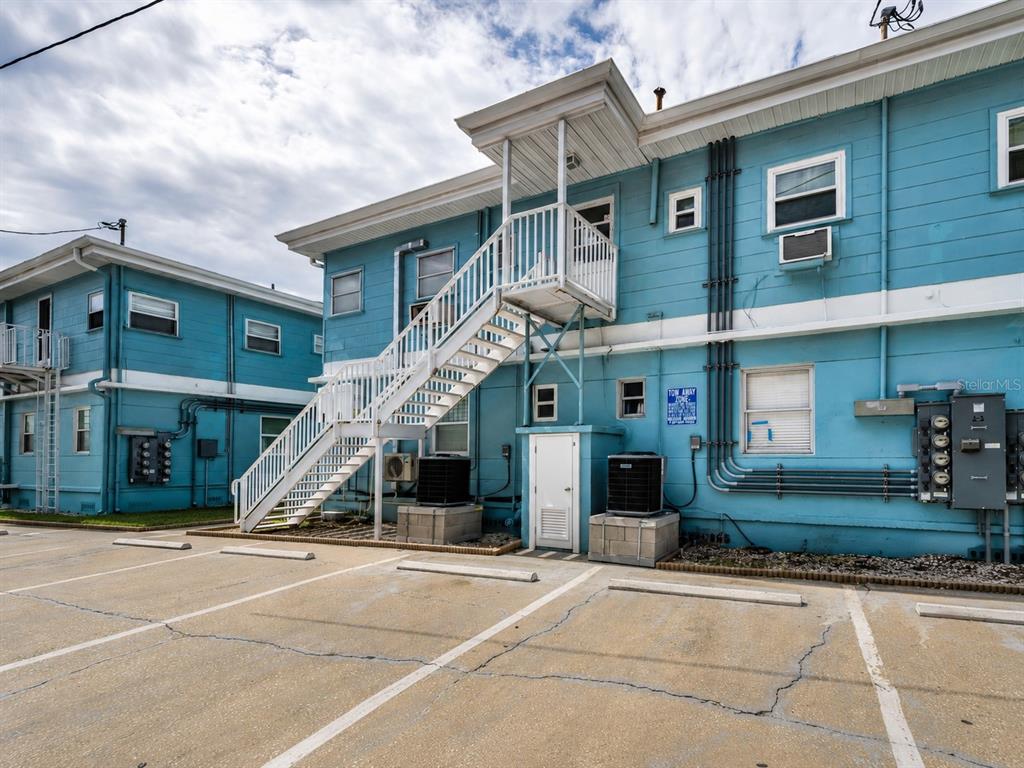 A bright blue two-story building features a Coral Resort sign and an office entrance — 483 E SHORE DRIVE UNIT A4, CLEARWATER BEACH, FL