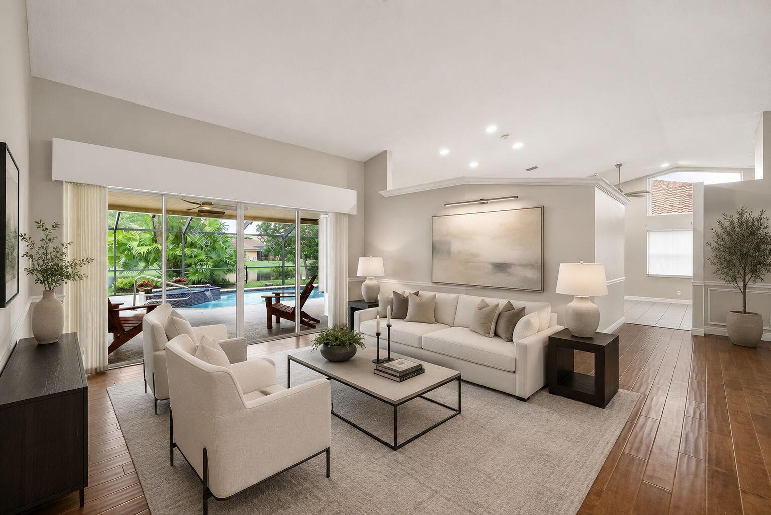 A bright living room features a white sofa, two armchairs, and sliding doors overlooking a pool — 1230 Fairfax Court, Weston FL 33326, WESTON, FL