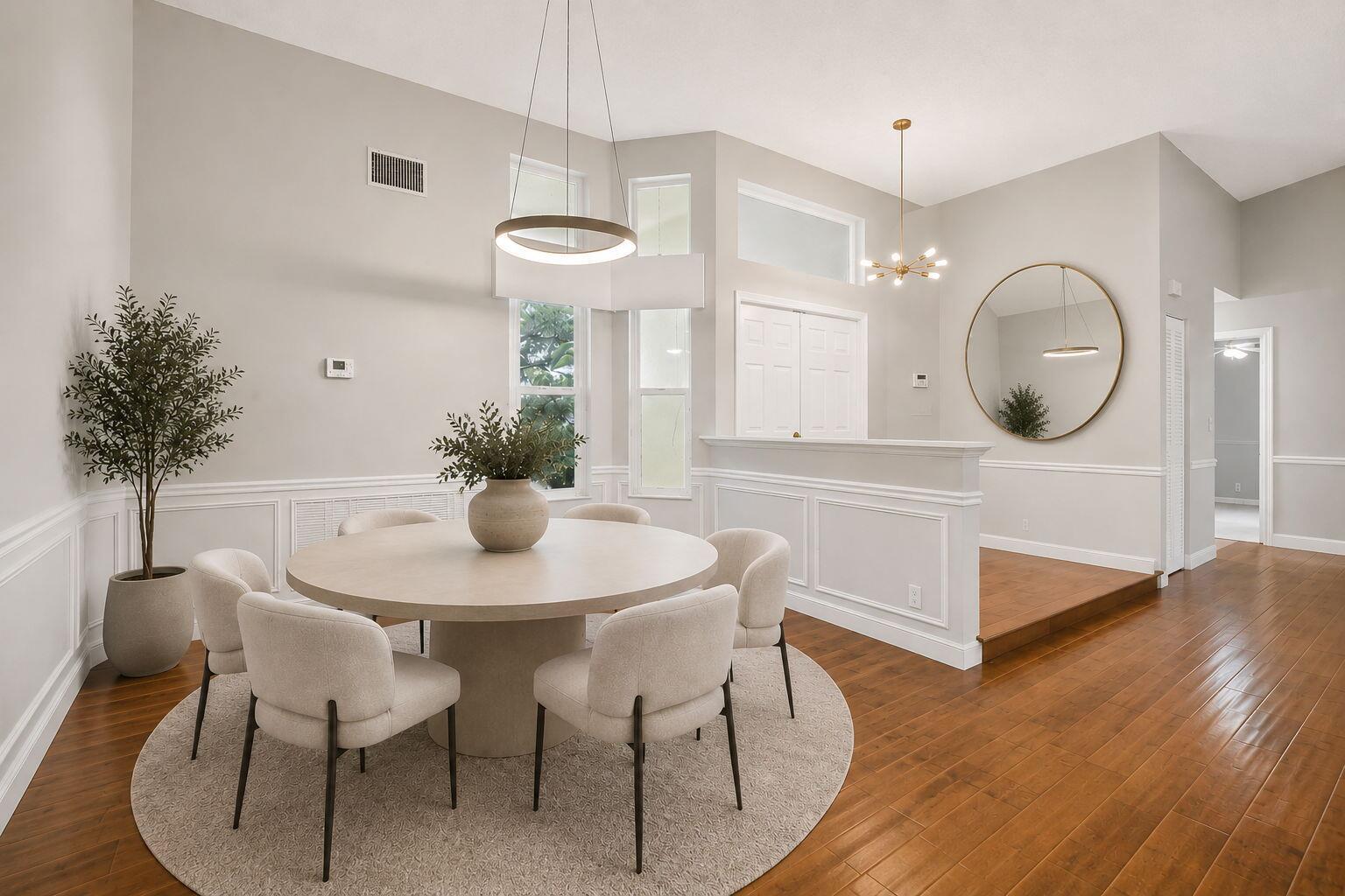 A kitchen with white upper cabinets, dark lower cabinets, a central island, and dining area — 1230 Fairfax Court, Weston FL 33326, WESTON, FL