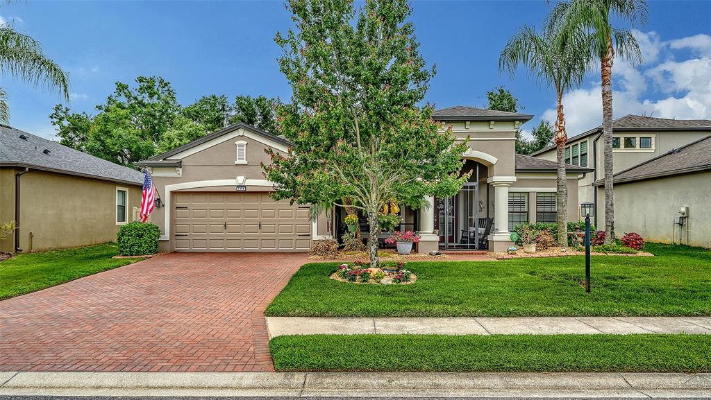 A single-story suburban house with a brick driveway, a two-car garage, and a front lawn — 766 129TH STREET NE, BRADENTON, FL