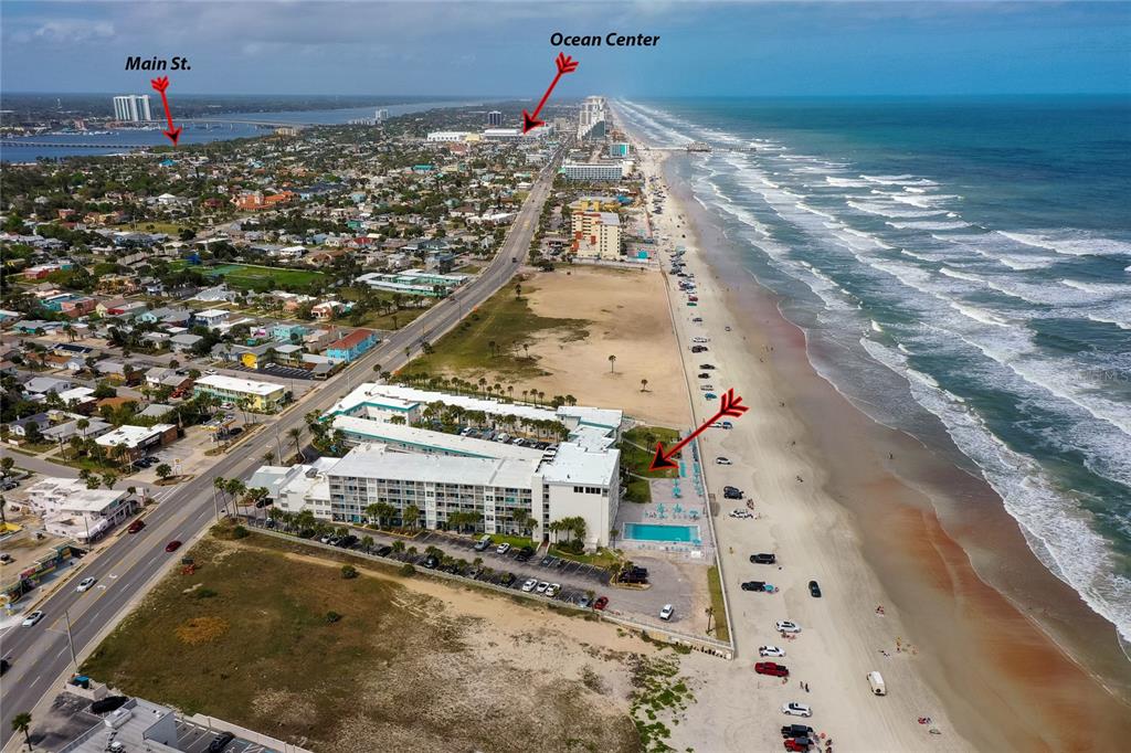 An aerial view shows a beachfront hotel with a pool and parking lot — 935 S ATLANTIC AVENUE UNIT 165, DAYTONA BEACH, FL