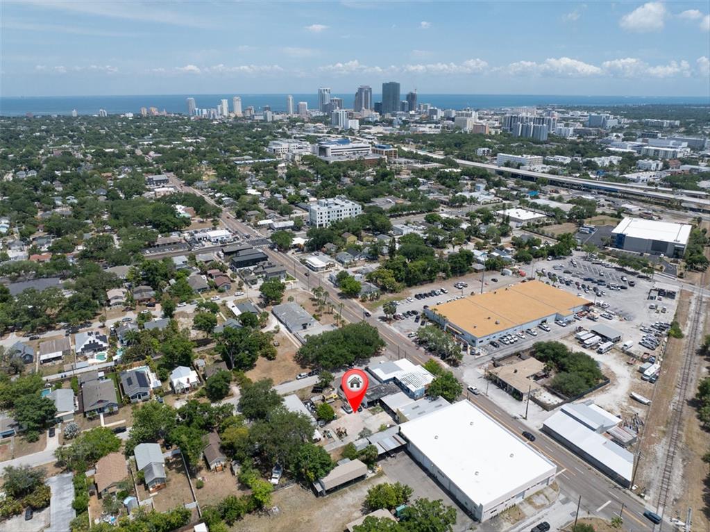An aerial view shows a commercial property with multiple buildings, parking areas, and surrounding streets — 1763 9TH AVENUE N, ST PETERSBURG, FL
