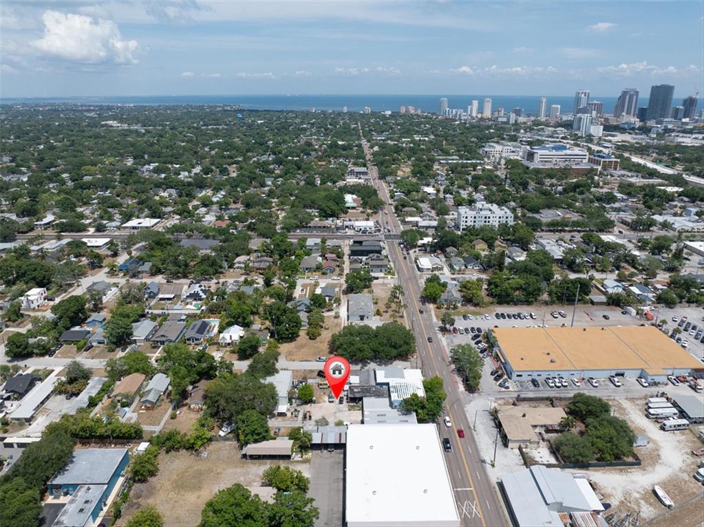 An aerial view shows a commercial property with a red location pin near a road — 1763 9TH AVENUE N, ST PETERSBURG, FL