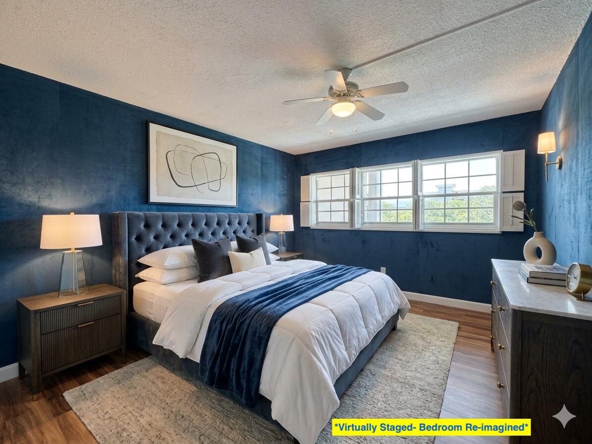 A bedroom features deep blue walls, a tufted headboard, and a ceiling fan — 2800 N Palm Aire Drive Unit 404, Pompano Beach FL 33069, POMPANO BEACH, FL