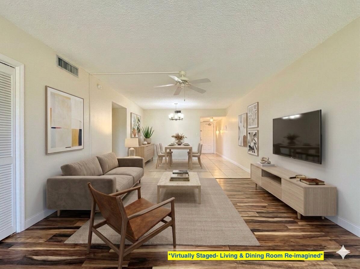 This is a virtually staged living and dining room with wood-look flooring and a ceiling fan — 2800 N Palm Aire Drive Unit 404, Pompano Beach FL 33069, POMPANO BEACH, FL