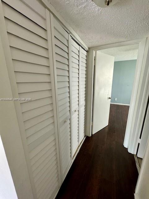 A hallway features white louvered closet doors on the left and dark wood-look flooring — 2029 NW 46th Ave # E202, Lauderhill FL 33313, LAUDERHILL, FL