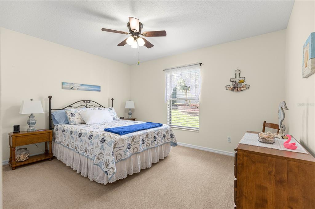 A covered entryway features light blue stucco walls, a tiled floor, and a white front door — 8721 SW 60 CIRCLE, OCALA, FL