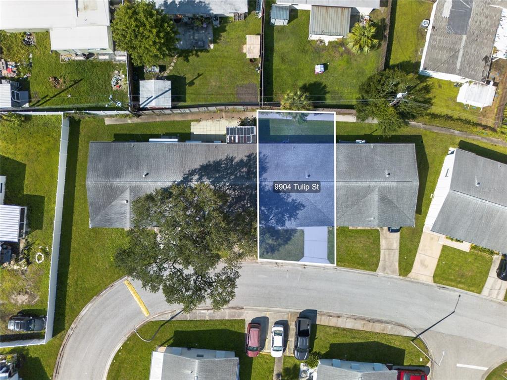 This aerial view shows a residential property with a highlighted roof and surrounding yard — 9904 TULIP STREET N, PINELLAS PARK, FL