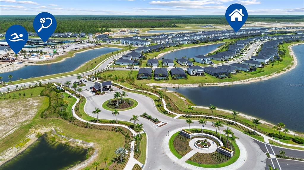 This aerial view shows a residential community with houses, lakes, and a gated entrance — 14867 WHITE PEARL ROAD, PUNTA GORDA, FL