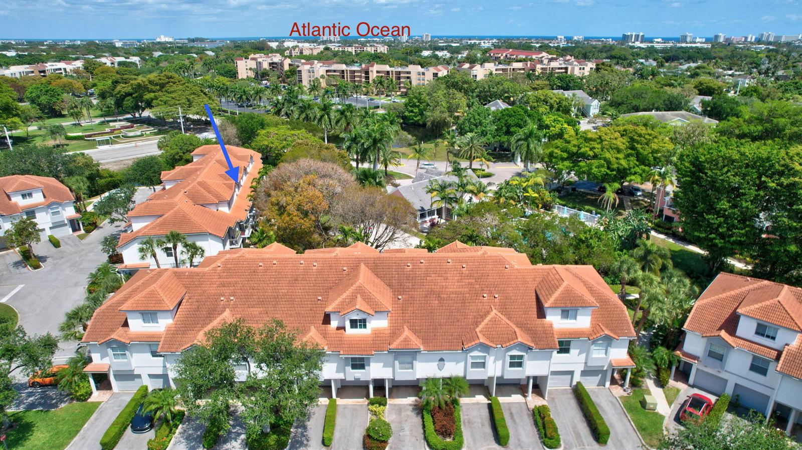 A living and dining area features wood-look flooring, a ceiling fan, and a balcony view — 2020 Alta Meadows Lane # 504, Delray Beach FL 33444, DELRAY BEACH, FL