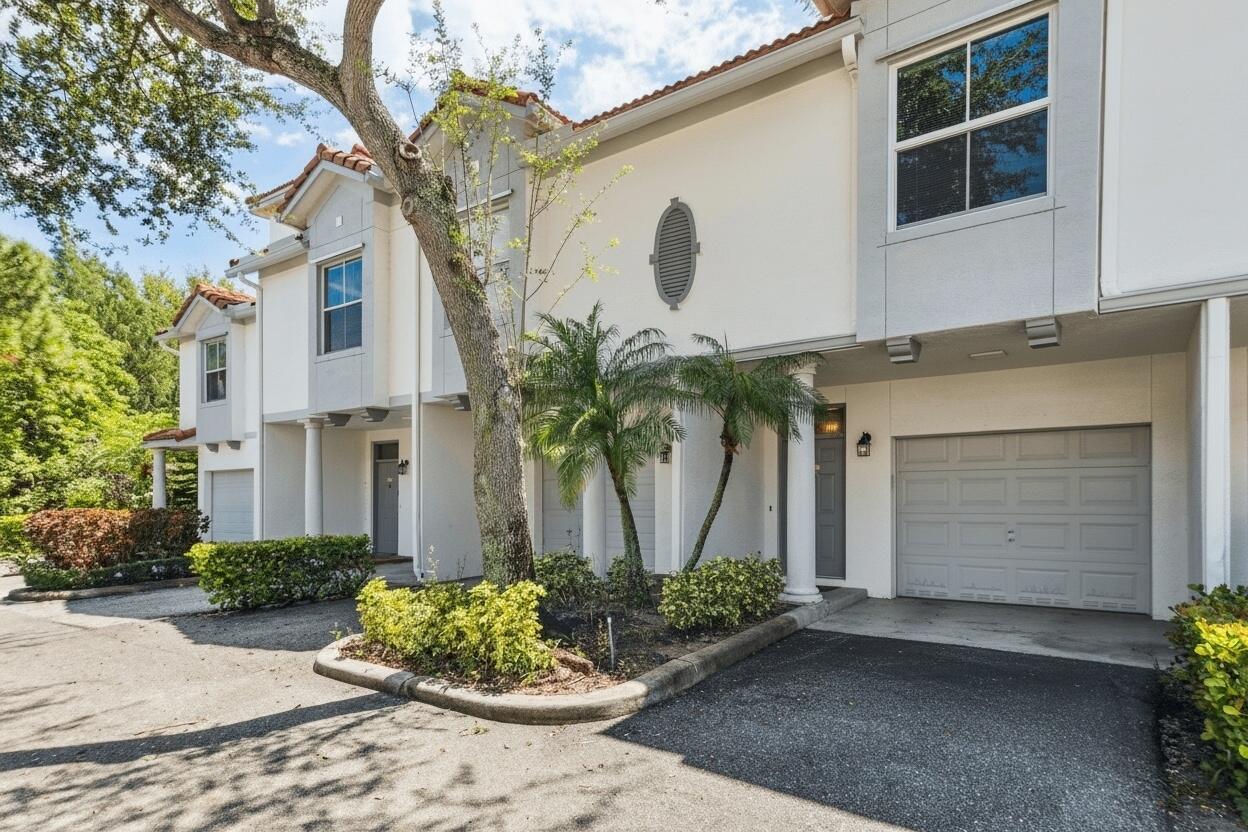 An aerial view of multi-story townhouses with terracotta tile roofs and surrounding green landscaping — 2020 Alta Meadows Lane # 504, Delray Beach FL 33444, DELRAY BEACH, FL