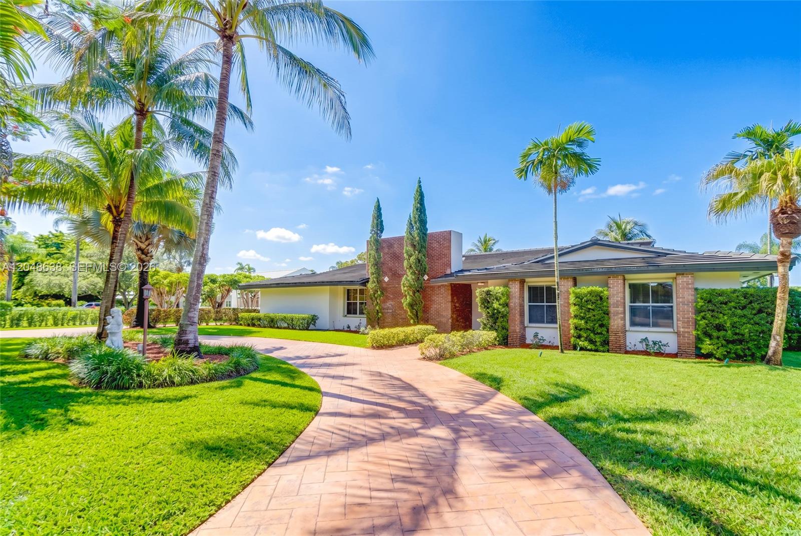 A single-story brick and stucco house features a curved paver driveway and palm trees — 14121 SW 97th Ave, Miami FL 33176, MIAMI, FL