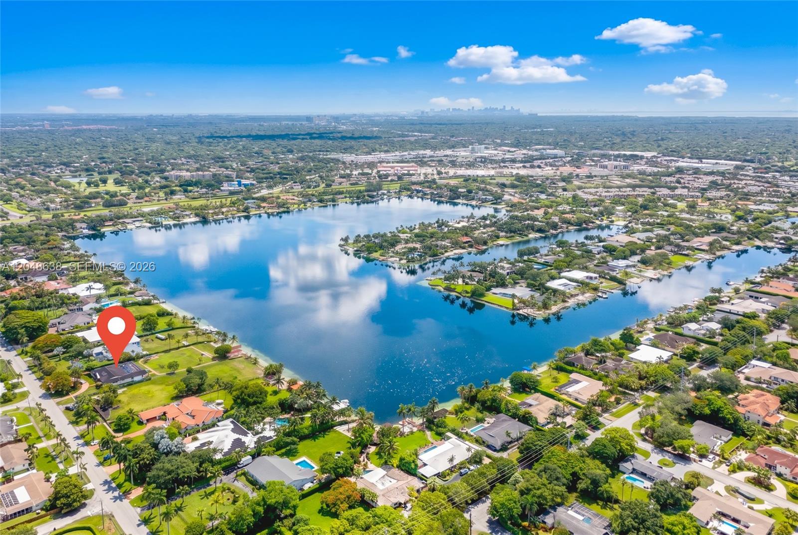 An aerial view shows a residential property with a red location pin near a lake — 14121 SW 97th Ave, Miami FL 33176, MIAMI, FL