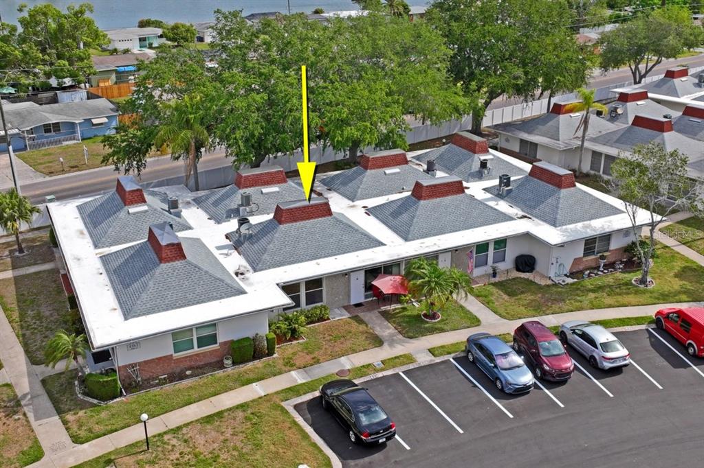 An aerial view shows a single-story multi-unit residential building with gray shingled roofs — 4363 TAHITIAN GARDENS CIRCLE UNIT B, HOLIDAY, FL