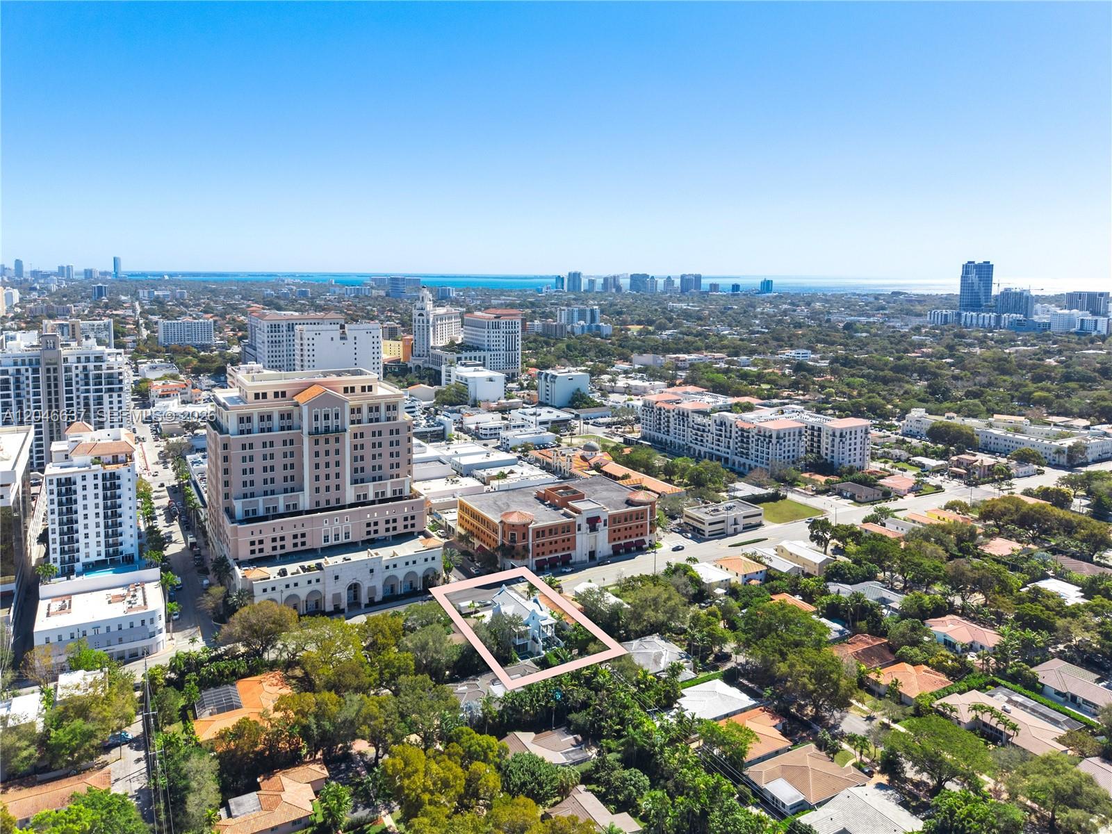 An aerial view shows a residential property highlighted in pink amidst a dense urban landscape — 2712 S Le Jeune Rd, Coral Gables FL 33134, CORAL GABLES, FL