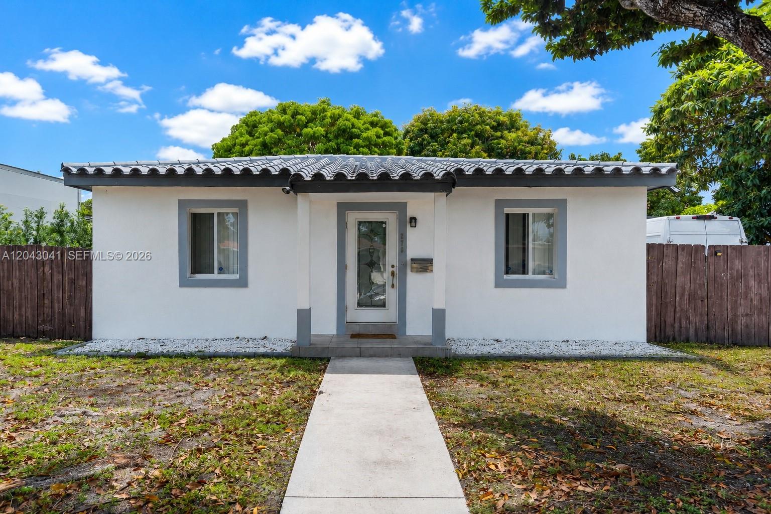 A single-story white house with a gray tiled roof and a central front entrance — 270 NW 51st Ave, Miami FL 33126, MIAMI, FL