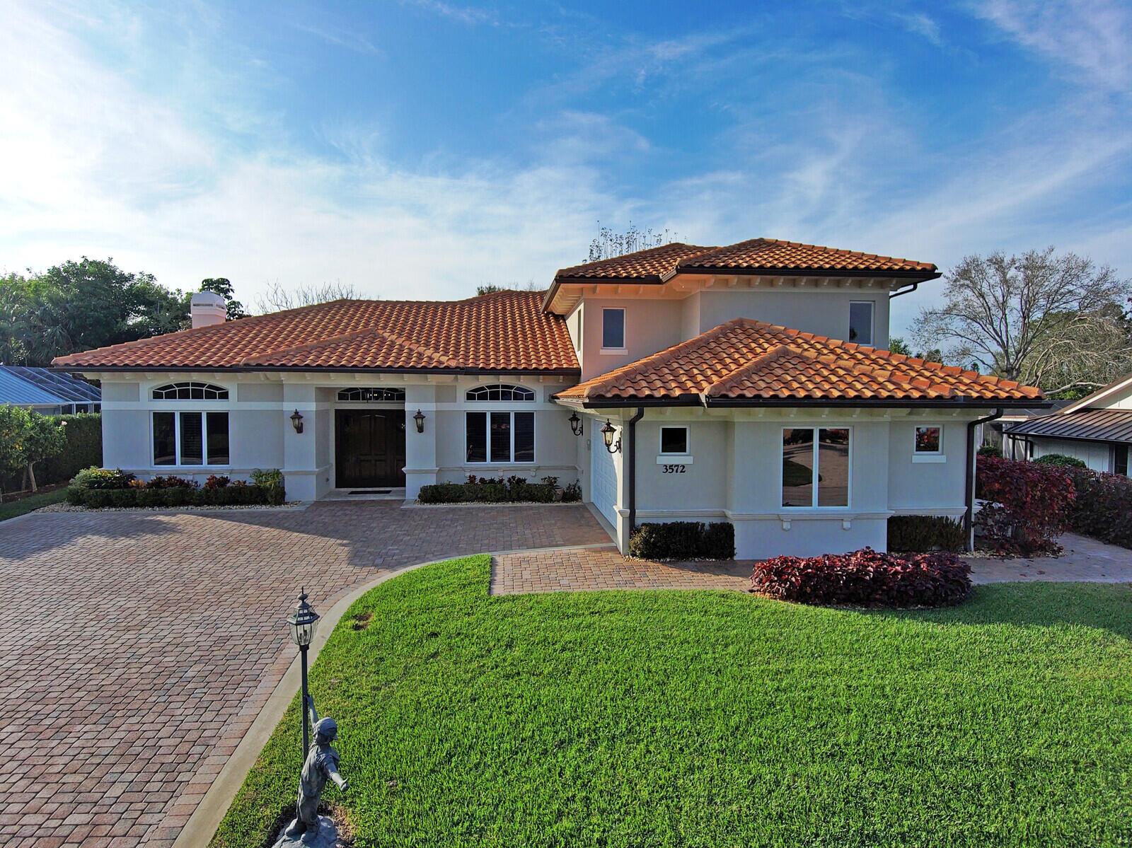 A two-story house with a terracotta tile roof and a brick paver driveway — 3572 SE Court Drive, Stuart FL 34997, STUART, FL