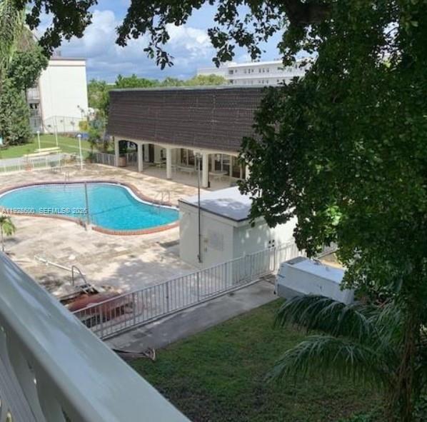 An outdoor swimming pool sits on a patio next to a building with a brown roof — 500 NE 2nd St # 317, Dania Beach FL 33004, DANIA BEACH, FL
