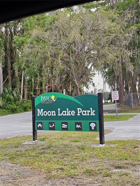 A green sign for Moon Lake Park stands in a grassy area with trees behind it — 00 VALIMAR ROAD, NEW PORT RICHEY, FL