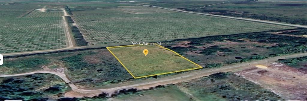 An aerial view shows a rectangular plot of vacant land outlined in yellow — 760 S WARFIELD ROAD, AVON PARK, FL