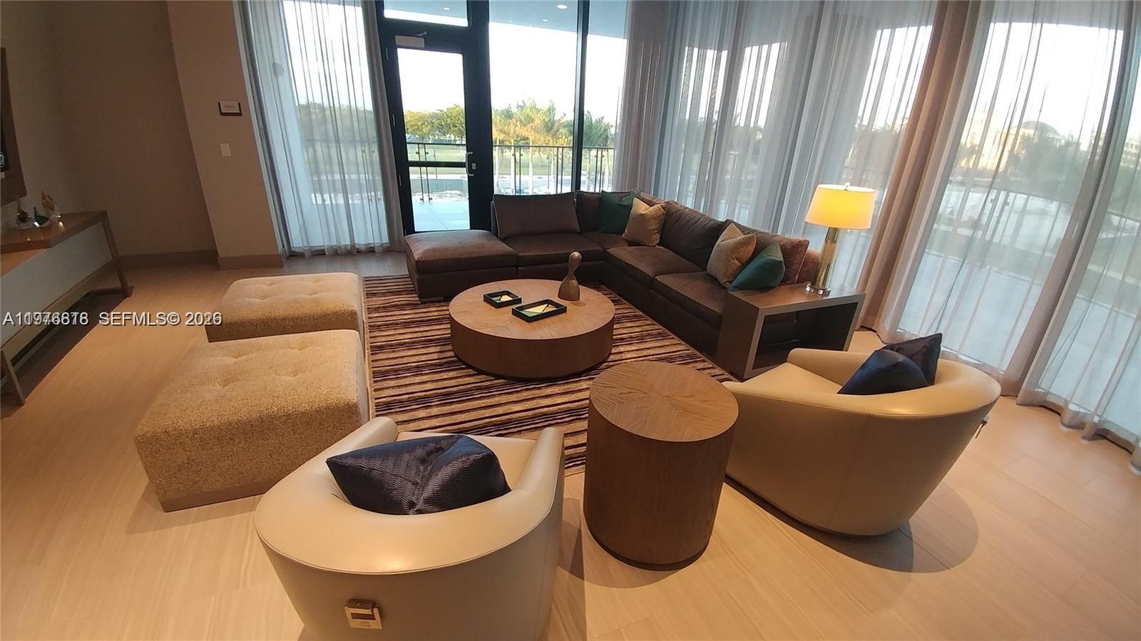 A modern living room features a sectional sofa, two armchairs, and a round coffee table — 5300 PASEO BLVD # 1603, Doral FL 33166, DORAL, FL