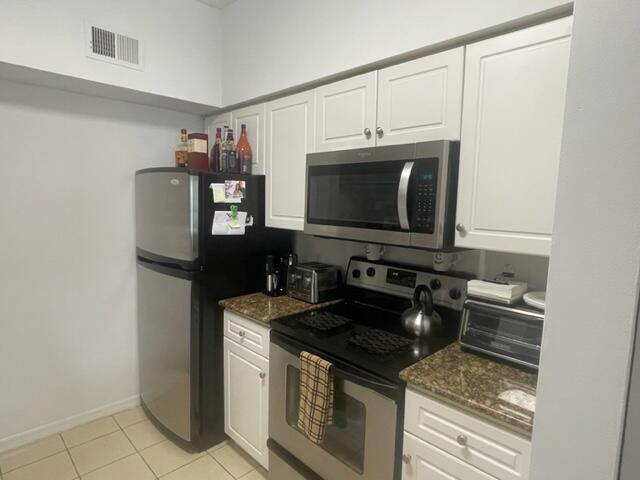 A kitchen features white cabinets, stainless steel appliances, and granite countertops — 3408 Tuscany Way, Boynton Beach FL 33435, BOYNTON BEACH, FL
