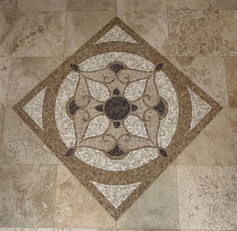 A decorative mosaic tile medallion is centered on a light-colored stone floor — 4810 SW 198 TERRACE, SOUTHWEST RANCHES, FL