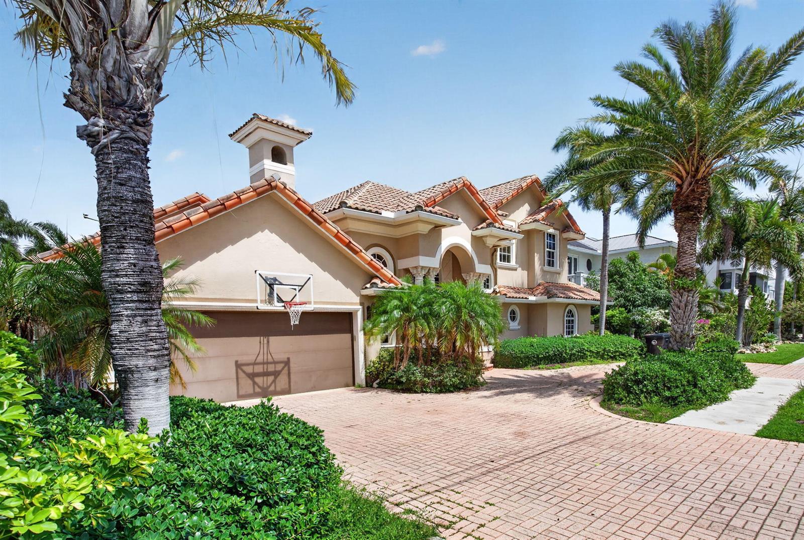 A two-story house with a tiled roof, a basketball hoop, and a paved driveway — 4901 NE 29th Avenue, Lighthouse Point FL 33064, LIGHTHOUSE POINT, FL