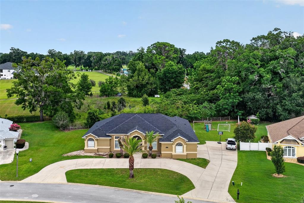 An aerial view shows a single-story house with a dark roof and a circular driveway — 485 NW 45TH LANE, OCALA, FL