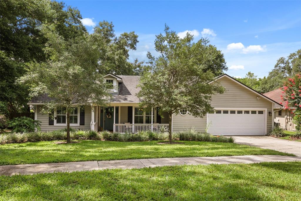 A single-story house with light-colored siding, a front porch, and an attached two-car garage — 2504 ORCHARD DRIVE, APOPKA, FL