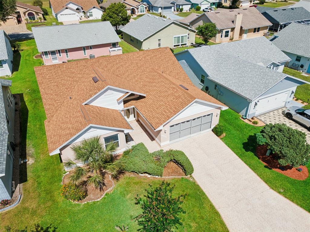 A single-story house with a tan exterior, a two-car garage, and a front lawn — 6232 EGRET DRIVE, LAKELAND, FL
