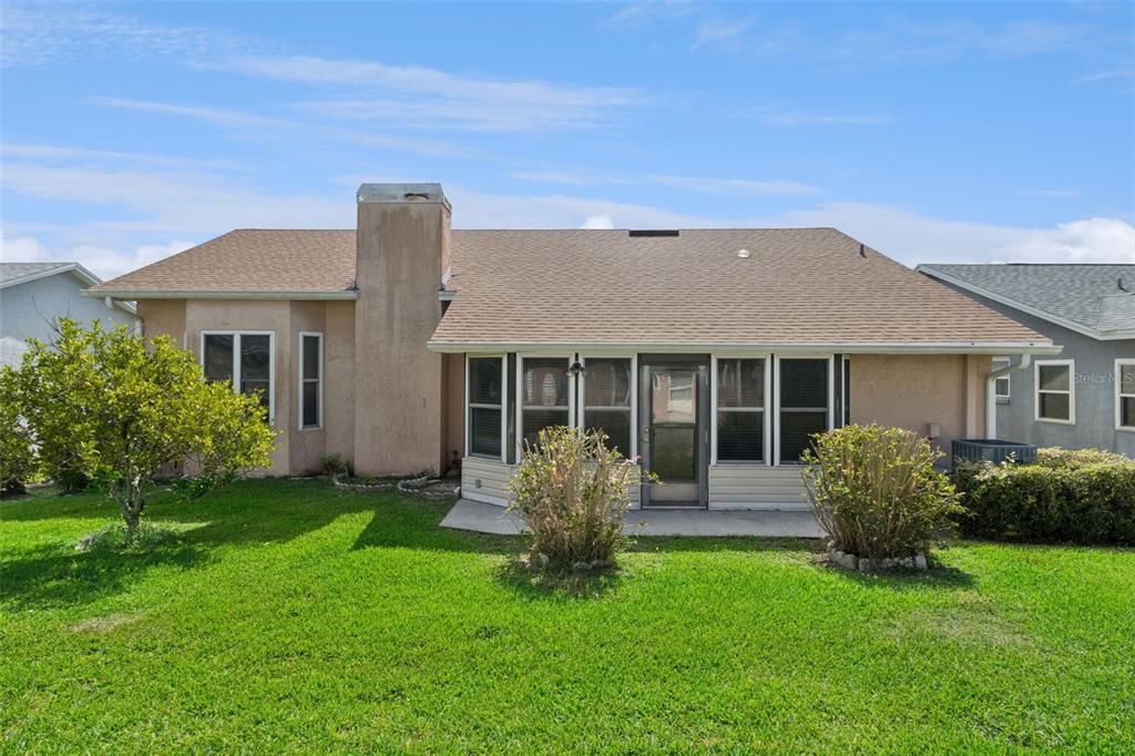 An aerial view shows a suburban house with a brown shingled roof and concrete driveway — 6232 EGRET DRIVE, LAKELAND, FL